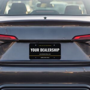 The back of a car on a dealership lot with a sample Dealer Plate Pro plate reading Your Dealership